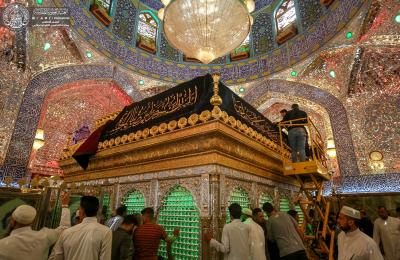 بالصور .. نشر معالم الحزن والسواد فوق الشباك المبارك لمرقد أمير المؤمنين عليه السلام إيذاناً ببدء مراسم محرم الحرام